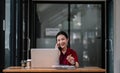 Portrait young asian businesswoman beautiful charming smiling and talking on the mobile phone in the office. female Royalty Free Stock Photo