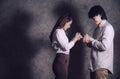 Asian Christian couple holding a crucifix rosary for prayer to God with faithfulness. Jesus Christ christian concept. Portrait Royalty Free Stock Photo