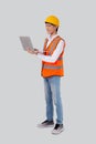 Portrait young asian engineer man looking laptop computer for planning isolated white background. Royalty Free Stock Photo