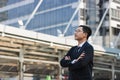 Portrait young Asian executive businessman in suit looking at far away outdoors. Business vision concept Royalty Free Stock Photo