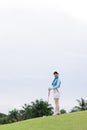 Portrait of young asian female golfer holding the golf club at the course Royalty Free Stock Photo