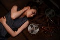Portrait of a young Asian girl in a blue striped dress lying on the couch next to the reels with magnetic tape