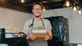 Portrait young Asian guy barista take receive order with menu feeling happy at urban cafe. Asia small business owner boy in apron Royalty Free Stock Photo