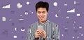 Portrait of young Asian guy using smartphone on violet background with business and money related icons, collage Royalty Free Stock Photo