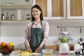 Portrait of a young asian housewife standing in kitchen Royalty Free Stock Photo