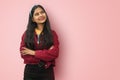  Portrait of young asian indian happy and smiling girl looking up, thinking of something fun and having an idea, concept