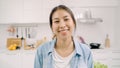 Portrait of young Asian Latin woman feeling happy smiling at home. Hispanic girl relax toothy smile looking to camera in kitchen