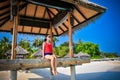 Portrait of young asian looking woman sitting in the hut at beautiful tropical beach