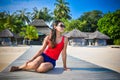 Portrait of young asian looking woman sitting near restaurant at beautiful tropical beach at Maldives