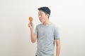 Young Asian man with fried chicken on hand Royalty Free Stock Photo