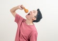 Young Asian man with fried chicken on hand Royalty Free Stock Photo