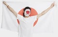 Portrait of young Asian man with Japanese flag smiling against white background Royalty Free Stock Photo