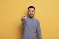 Portrait of young asian man pointing index finger at camera Royalty Free Stock Photo