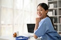 Young Asian medical student smiling and sitting in the study room Royalty Free Stock Photo