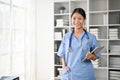 Portrait of young Asian medical student smiling and standing in the study room Royalty Free Stock Photo