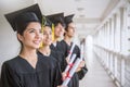 Portrait of young asian man and woman graduates standing in line