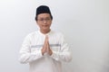 young Asian muslim man showing apologize and welcome hand gesture. Isolated image on white background Royalty Free Stock Photo