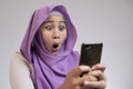 Young Muslim Woman Get Good News on Her Phone Royalty Free Stock Photo