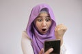 Young Muslim Woman Get Good News on Her Phone Royalty Free Stock Photo