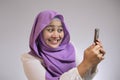 Young Muslim Woman Get Shock Surprised Get Good News on Her Phone Royalty Free Stock Photo