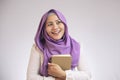 Muslim Woman Holding Book, Thinking and Smiling Royalty Free Stock Photo