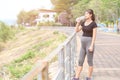 Portrait of young Asian pregnant woman drinking clean water after her relaxing and workout in the park Royalty Free Stock Photo