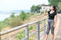 Portrait of young Asian pregnant woman drinking clean water after her relaxing and workout in the park Royalty Free Stock Photo