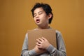 Portrait of young Asian student boy tired slept and yawning when reading a book, student tired when studying hard