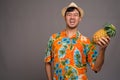 Portrait of young Asian tourist man holding pineapple Royalty Free Stock Photo