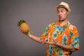 Portrait of young Asian tourist man holding pineapple Royalty Free Stock Photo