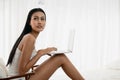 Portrait of young asian woman in casual waer using laptop computer Royalty Free Stock Photo