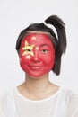 Portrait of young Asian woman with Chinese flag painted on face against white background Royalty Free Stock Photo