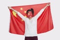 Portrait of young Asian woman with Chinese flag and painted face against white background Royalty Free Stock Photo