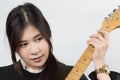 Portrait of young Asian woman enjoys playing guitar. Royalty Free Stock Photo