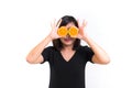 Portrait of young Asian woman. holding orange slices in front of her eyes and smile over a white background. Royalty Free Stock Photo