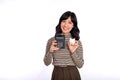 Portrait of young Asian woman casual uniform holding white piggy bank and calculator  on white background, Financial and Royalty Free Stock Photo