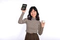 Portrait of young Asian woman casual uniform holding white piggy bank and calculator isolated on white background, Financial and Royalty Free Stock Photo