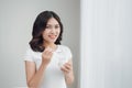 Portrait of young asian woman at home eating yogurt Royalty Free Stock Photo