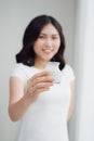 Portrait of young asian woman at home eating yogurt Royalty Free Stock Photo