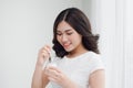 Portrait of young asian woman at home eating yogurt Royalty Free Stock Photo