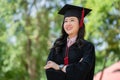 Portrait of young asian woman outside the building on her graduated day. Education success graduate concept Royalty Free Stock Photo