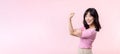 Portrait young asian woman proud and confident showing strong muscle strength arms flexed posing, feels about her success