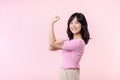 Portrait young asian woman proud and confident showing strong muscle strength arms flexed posing, feels about her success
