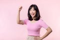 Portrait young asian woman proud and confident showing strong muscle strength arms flexed posing, feels about her success