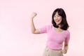 Portrait young asian woman proud and confident showing strong muscle strength arms flexed posing, feels about her success