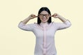 Portrait of a young asian woman putting fingers in her both ears. Royalty Free Stock Photo