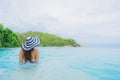 Portrait young asian woman relax smile happy around outdoor swimming pool in hotel resort with sea ocean view Royalty Free Stock Photo