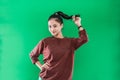 portrait young Asian woman smiling face while holding her long black hair up and looking to the camera Royalty Free Stock Photo