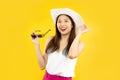 portrait of young asian woman smiling in trendy summer clothes posing isolated on yellow wall in studio. travel airlines concept