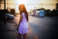 Portrait of young asian woman standing side of street at sunset moment,filtered image,soft focus Royalty Free Stock Photo